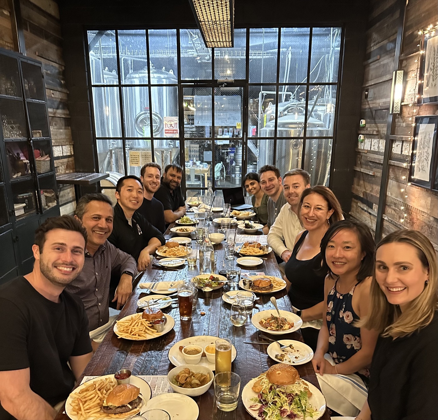 The Outcome team gathered around a table at a team dinner