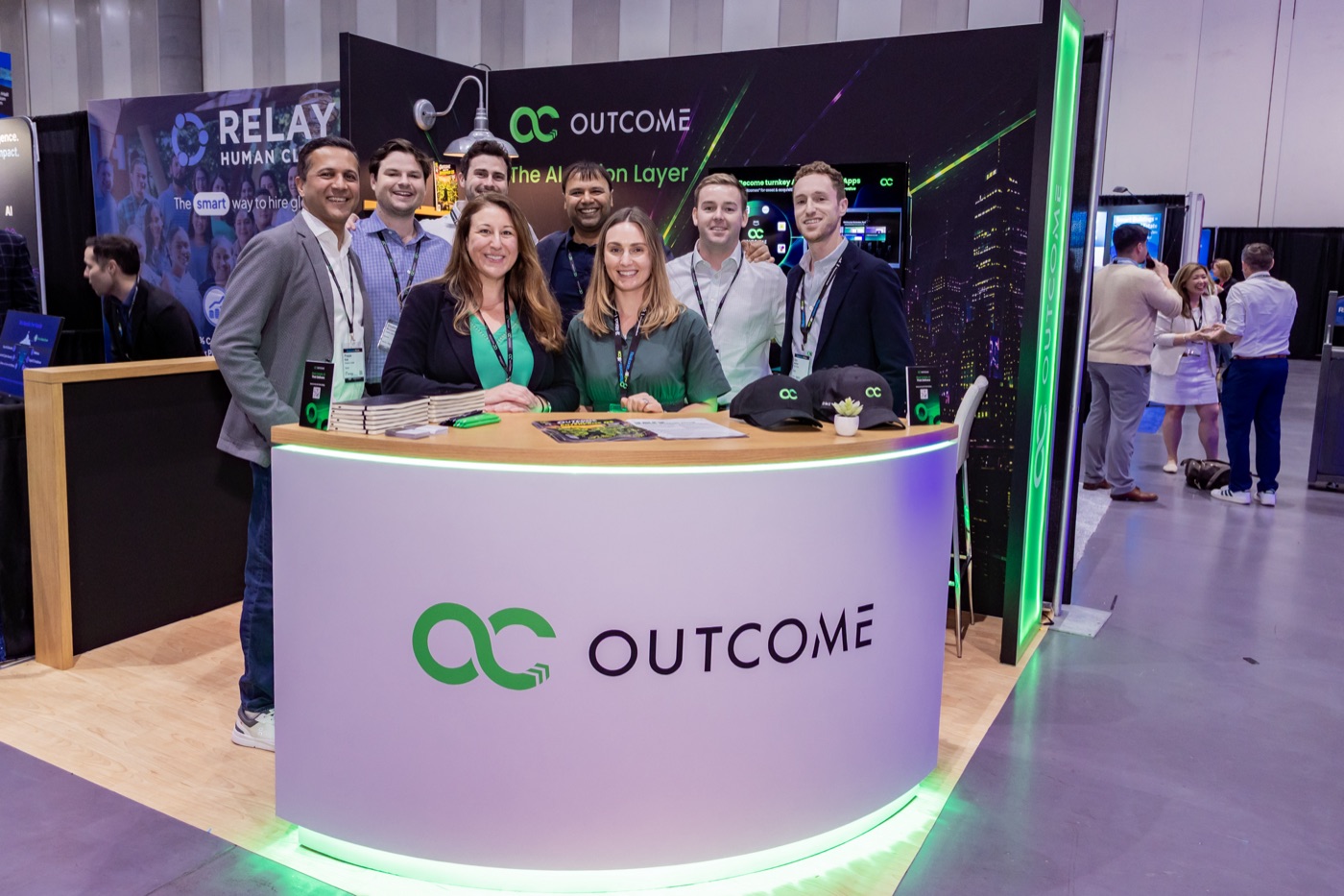 The Outcome team at the company booth during a real estate conference